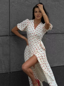 Detail of white wrap dress with red heart prints, V-neck, and puff sleeves for summer