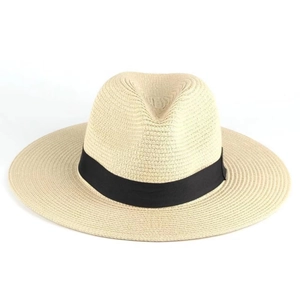Detailed close-up of straw sun hat weave texture and black grosgrain ribbon band