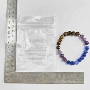 Detail view of natural stone bead bracelet with scale measurement tool for size reference