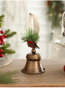 Detail of vintage bronze Christmas bell with pine needles and rustic jute rope loop