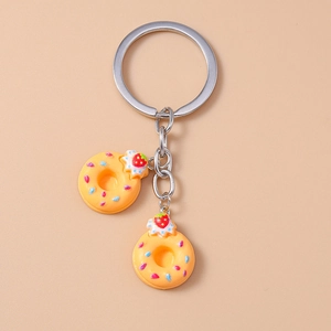 Detailed view of donut keychain with metallic ring and realistic resin charms