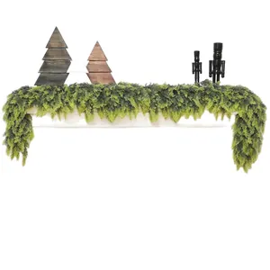 Green Norfolk pine garland set with wooden trees and nutcrackers on a white background