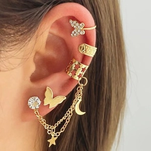 Detail of bohemian gold leaf and butterfly ear cuff set with sparkling crystal accents