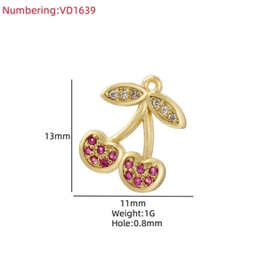 Detail view of 13x11mm cherry charm with red zircon inlay and gold plating