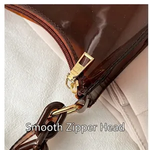 Fashionable brown transparent jelly bag with smooth gold zipper and chunky chain detail
