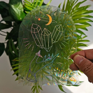 Holographic suncatcher window film with moon and crystal design in natural sunlight