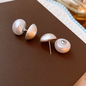 Macro shot of pearl stud earrings with matte silver hardware and disassembled structure