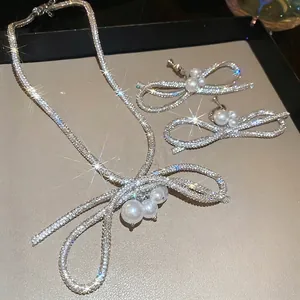 Elegant diamond bow and pearl jewelry set with necklace and clip earrings for women