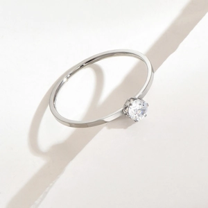 Minimalist 1mm titanium steel ring with a single round zircon in a four-prong setting