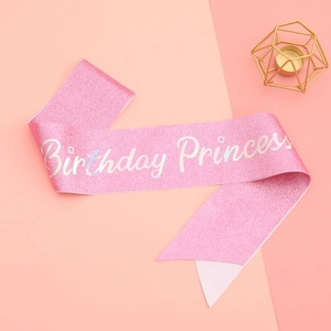 Detailed view of pink glitter birthday princess sash with holographic silver lettering