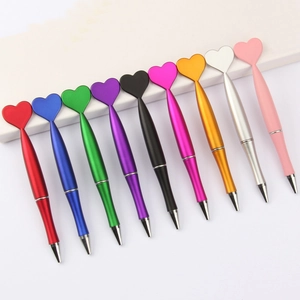 Set of 10 heart-shaped ballpoint pens in metallic colors on a clean white background