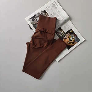 Detail of coffee brown seamless ribbed yoga pants with a high waist tummy control band