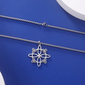 Detailed close-up of a silver stainless steel Trisquel pendant on a box chain