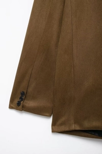 Detailed close-up of brown suede jacket sleeve featuring three stylish black buttons