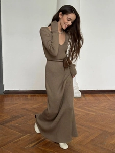 Detailed view of the vertical ribbed knit texture on a V-neck long-sleeve midi dress