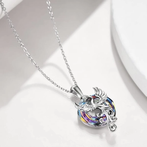 Silver phoenix pendant necklace with colorful crystal wings on a white background