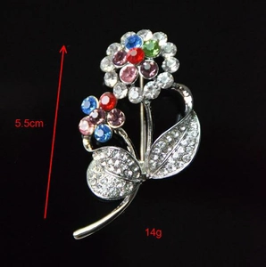 Macro detail of 5.5cm floral brooch with multicolor rhinestones and silver alloy base