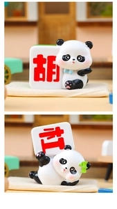 Detailed view of resin panda figurines holding mahjong tiles in two playful poses