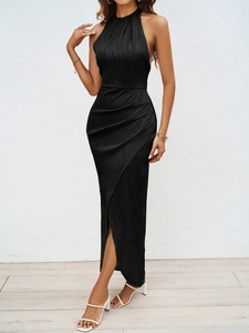 Detailed view of the black halter neck dress featuring textured pleated fabric and side slit