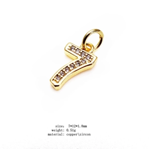 Macro shot of 14K gold plated number 7 charm with micro-set cubic zirconia stones