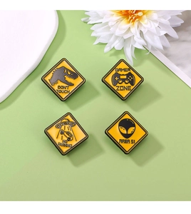 Set of 4 yellow PVC shoe charms featuring dinosaur, gamer zone, UFO, and area 51 signs