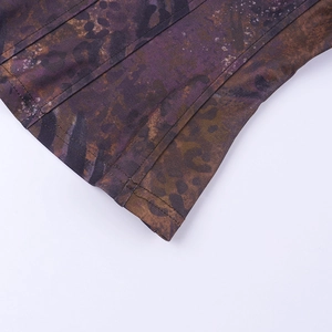 Macro shot of double-needle hem stitching on a purple and brown leopard print fabric