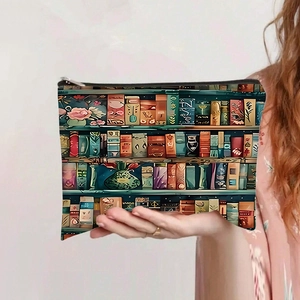 Detail of large canvas pouch with vintage bookshelf print held in hand with zip closure