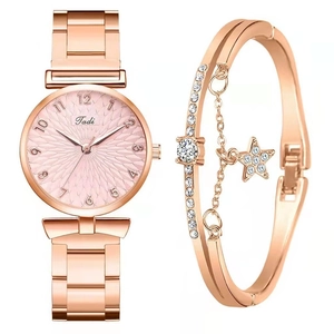 Detail of rose gold Tadi watch with star bracelet set featuring white stones
