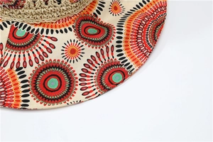 Detail of bohemian sun hat featuring colorful mandala patterns and straw weaving texture