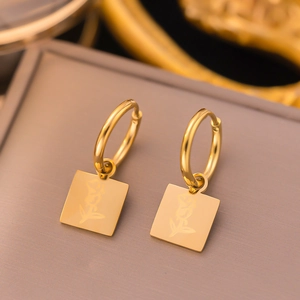 Gold plated stainless steel square coin earrings featuring an engraved rose flower design