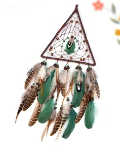 Detailed view of triangular dreamcatcher with green feathers and natural wood beads