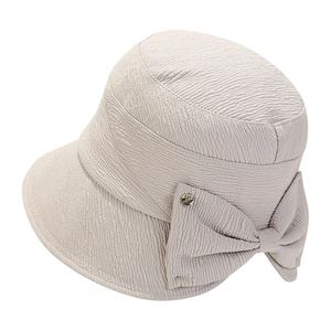 Chic beige bow bucket hat with bubble texture fabric and gold metallic detail