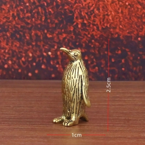 Detailed macro view showing the 2.5cm height and 1cm width of the brass penguin figurine