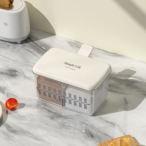 Transparent plastic food storage box with beige lid on marble countertop kitchen setting