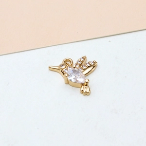 Detailed view of hummingbird pendant with gold plating and teardrop cubic zirconia