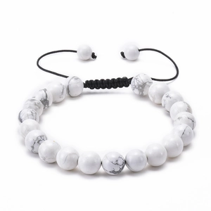 Detail of hand-woven adjustable bracelet with white marble beads and black cord