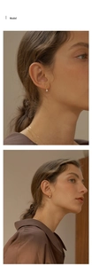 Detail view of gold pear-shaped zircon earrings shown on a model for elegant styling