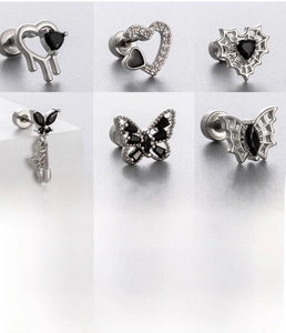 Detailed set of gothic silver ear studs featuring spider web, butterfly and zircon heart