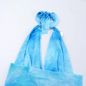 Detail of blue tie-dye floral halter neck fabric and texture on women's mini dress