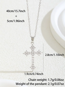 Macro shot of silver cross pendant with clear cubic zirconia and jewelry dimensions