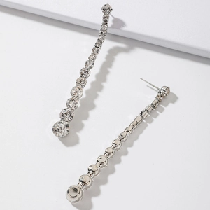 Detailed close-up of silver tassel earrings featuring sparkling crystal rhinestones