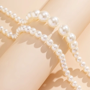 Macro shot of layered cream faux pearls with soft luster on an aesthetic display