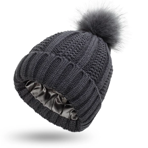 Detail of soft dark grey knit beanie featuring a smooth satin lining for hair protection