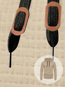Macro detail of men's beige waffle hoodie featuring black woven drawstrings and leather accents