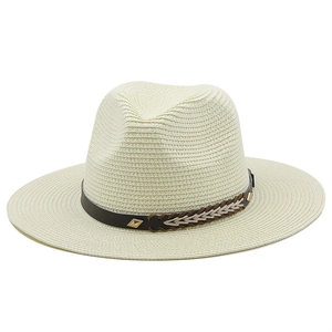 Close-up of fedora straw hat with dark brown leather band and gold metal buckle