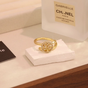 Elegant gold-tone tree of life open ring with micro-set cubic zirconia on a stone base
