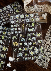 Detailed view of 3D floral acrylic stickers for DIY phone cases on a rustic wood background