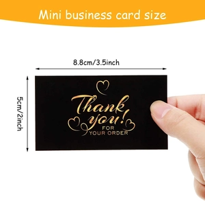 Mini business card size 8.8x5cm black and gold thank you labels held by hand