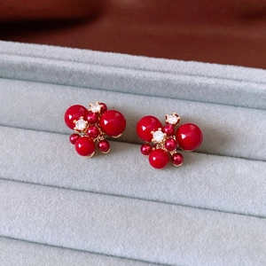 Detail of red bead cluster earrings with zircons in a luxury velvet jewelry box