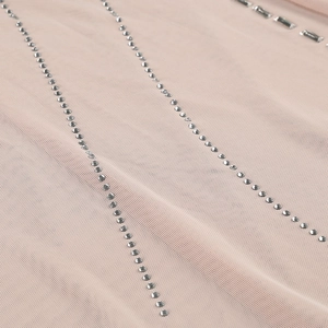 Detailed close-up of rhinestone embellishments and mesh fabric on a sexy fishtail dress